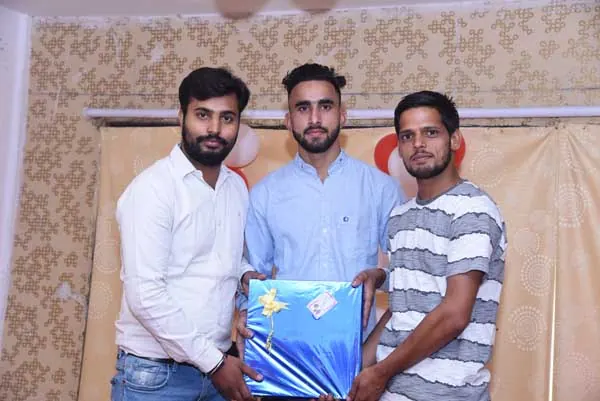 Students receiving a gift at an OSPMI campus event